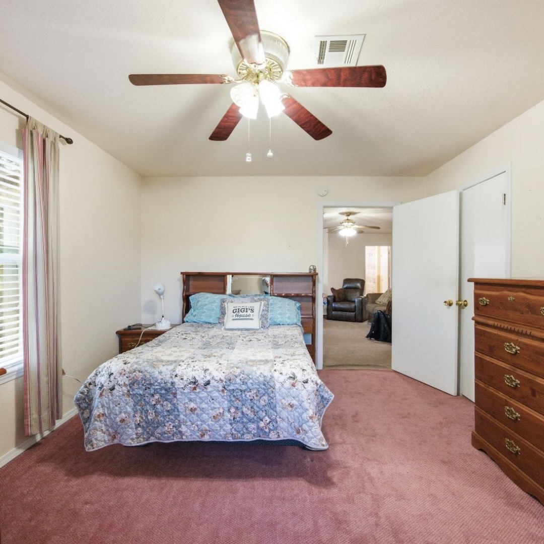 2696 Russellville Road Quinton, OK 74561 - Photo 16 of 40 Master Bedroom featuring a ceiling fan with integrated lighting, a window with horizontal blinds, and a doorway opening to an additional interior space