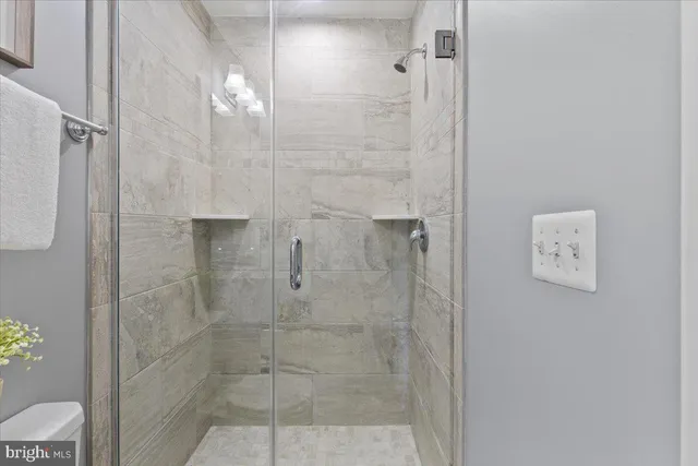 a view of entryway and gallery with wooden floor