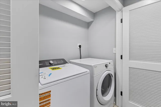 a view of a balcony with wooden chairs