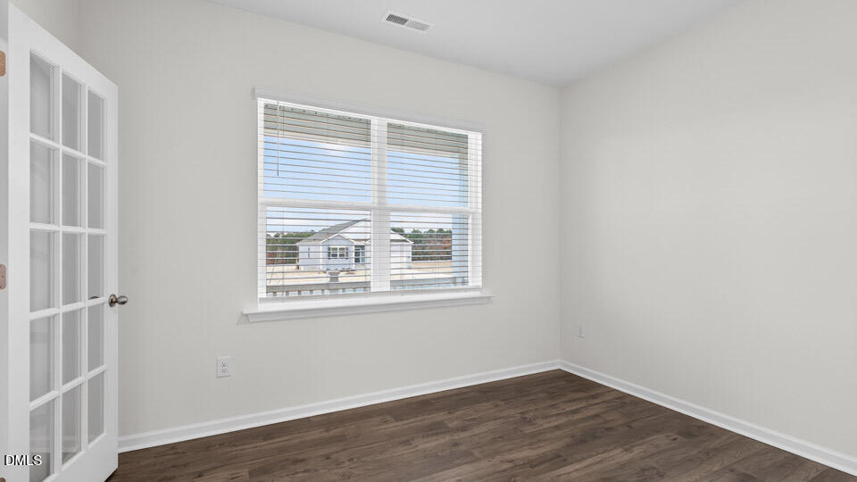 138 Fair Child Road Spring Lake, NC 28390 - Photo 7 of 45 an empty room with wooden floor and windows