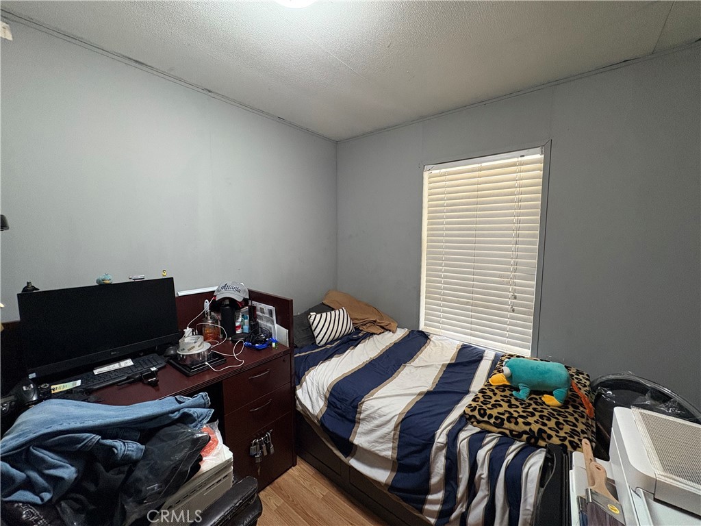 23500 The Old Road, Unit 37 Newhall, CA 91321 - Photo 16 of 22 a bedroom with a bed and two windows