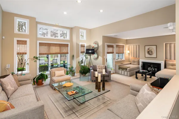 a living room with furniture large window and a table