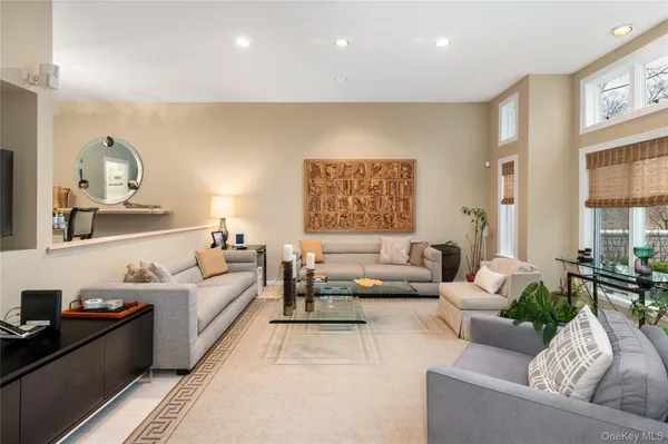 a living room with furniture and painting on the wall