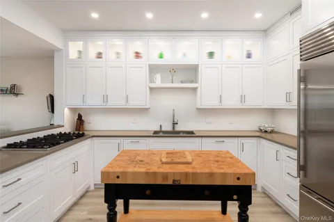 a kitchen with stainless steel appliances granite countertop a sink and cabinets