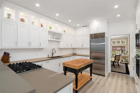 a kitchen with refrigerator a stove a sink and a cabinets