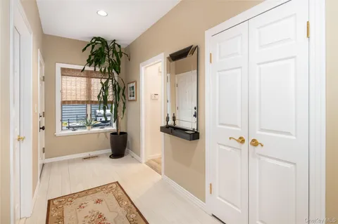 a view of a hallway with windows and closet