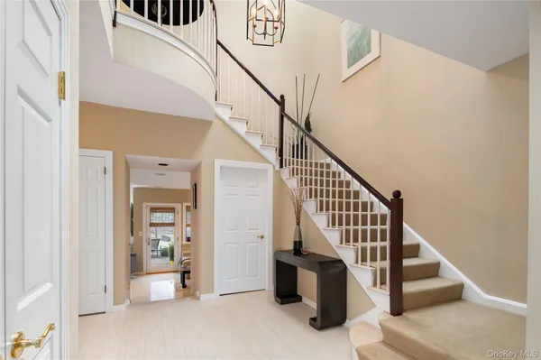 a view of entryway and hall with wooden floor