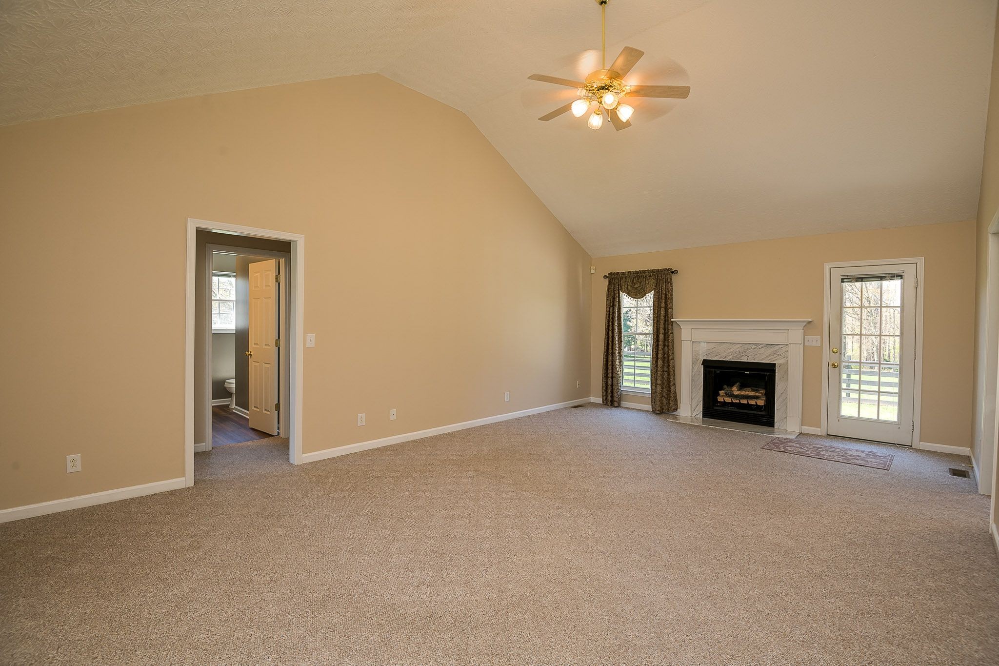 4165 Mt Zion Road Springfield, TN 37172 - Photo 21 of 42 a view of a room with chandelier fan and a fireplace