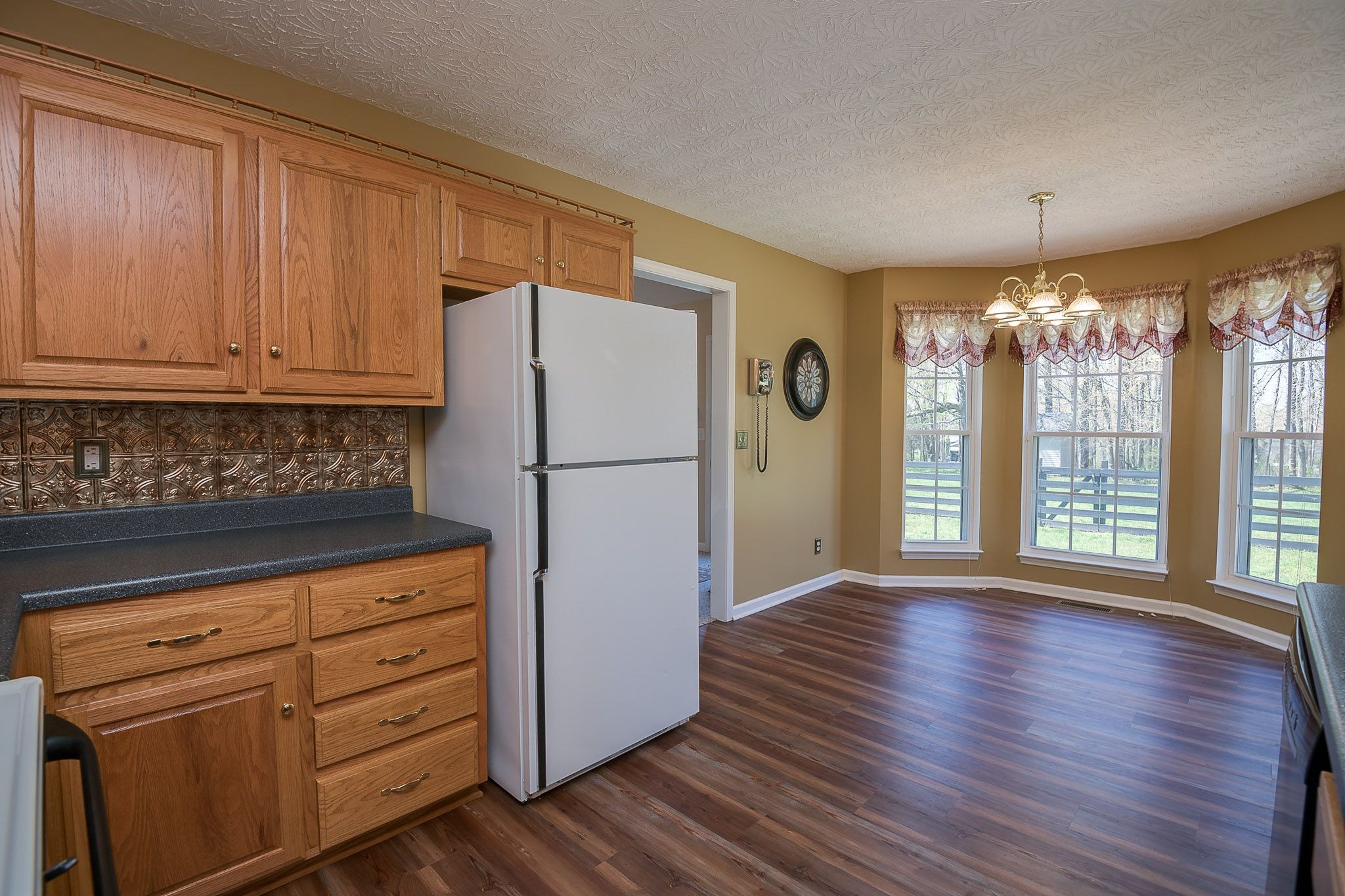 4165 Mt Zion Road Springfield, TN 37172 - Photo 26 of 42 a kitchen with granite countertop wooden cabinets and a refrigerator