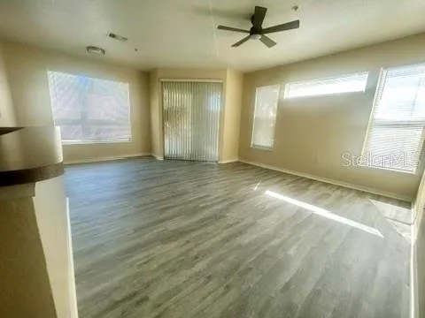 wooden floor in an empty room with a window