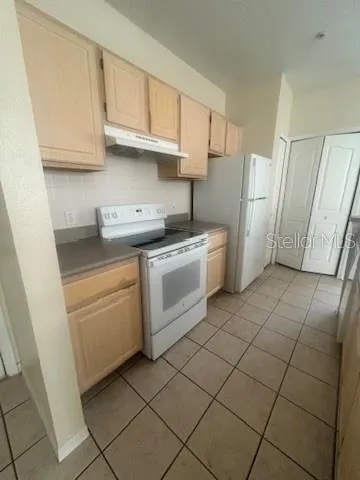 a kitchen with a stove top oven sink and cabinets
