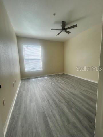 5807 Legacy Crescent Place, Unit 202 Riverview, FL 33578 - Photo 9 of 13 wooden floor in an empty room with a window