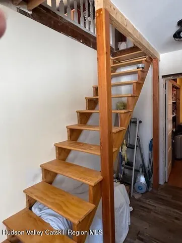 a view of a hallway with furniture and staircase