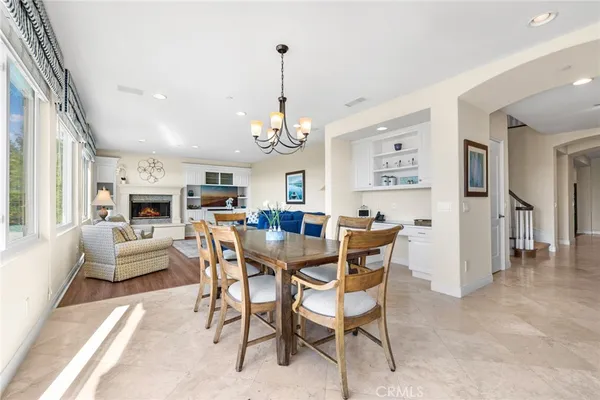 a living room with stainless steel appliances kitchen island granite countertop a stove a sink and a refrigerator