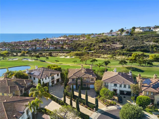 an aerial view of multiple houses with a yard