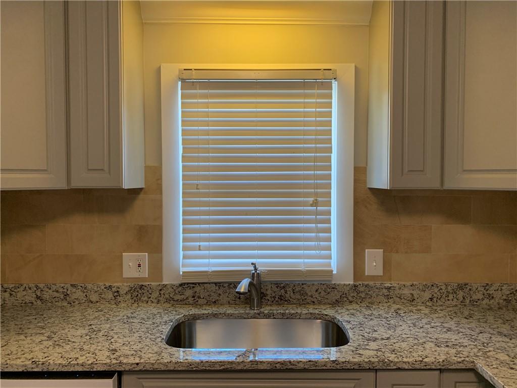 1261 Concord Road Southeast Smyrna, GA 30080 - Photo 21 of 50 a kitchen with granite countertop white cabinets and a sink