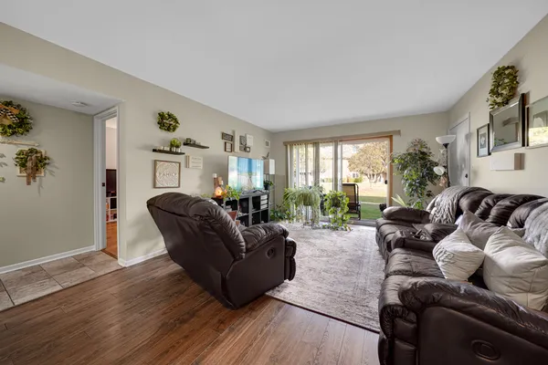 a living room with furniture window and wooden floor