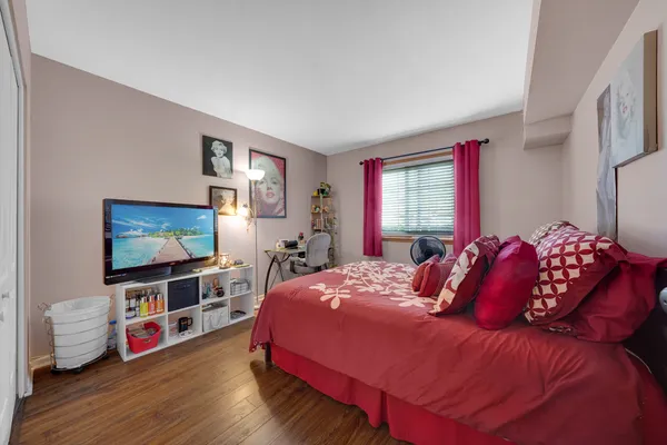 a bedroom with a bed and a flat screen tv