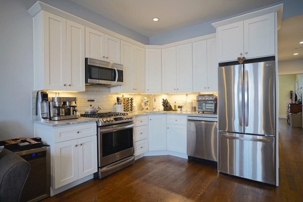 249 Lexington Street, Unit 2 Boston, MA 02128 - Photo 1 of 28 a kitchen with a refrigerator stove and white cabinets