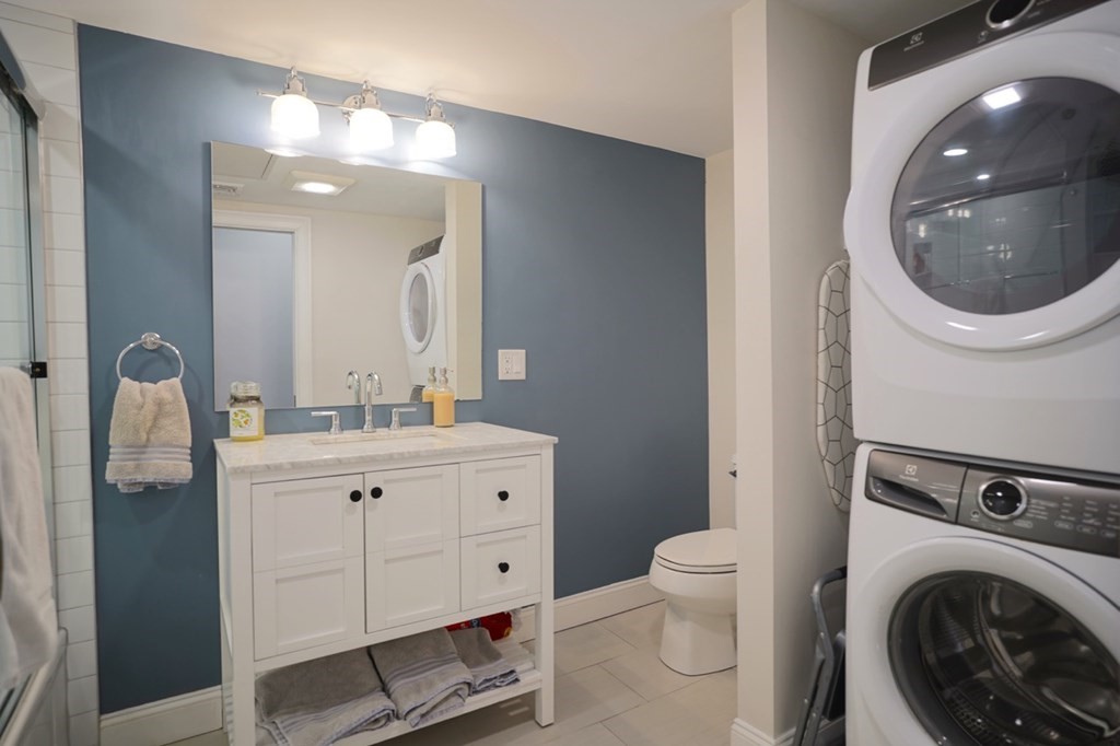 249 Lexington Street, Unit 2 Boston, MA 02128 - Photo 14 of 28 a spacious bathroom with a toilet a sink and mirror