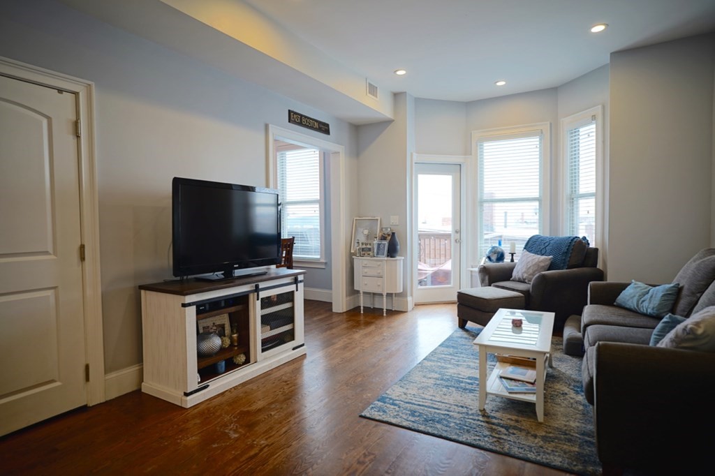 249 Lexington Street, Unit 2 Boston, MA 02128 - Photo 2 of 28 a living room with furniture and a flat screen tv