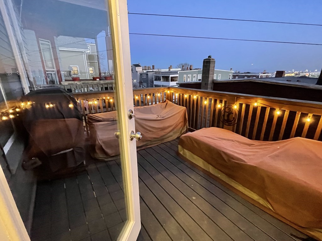 249 Lexington Street, Unit 2 Boston, MA 02128 - Photo 26 of 28 a balcony with wooden floor table and chairs