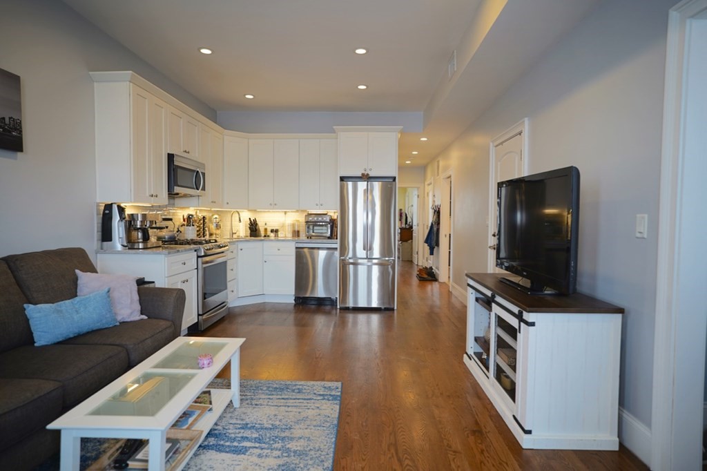 249 Lexington Street, Unit 2 Boston, MA 02128 - Photo 5 of 28 a living room with stainless steel appliances furniture and a flat screen tv