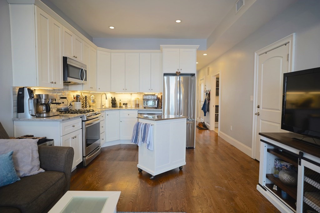 249 Lexington Street, Unit 2 Boston, MA 02128 - Photo 6 of 28 a living room with stainless steel appliances furniture and a flat screen tv