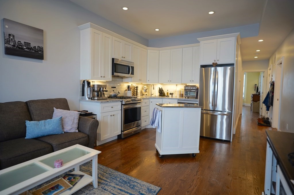 249 Lexington Street, Unit 2 Boston, MA 02128 - Photo 7 of 28 a kitchen with stainless steel appliances granite countertop a refrigerator a stove top oven a sink and dishwasher