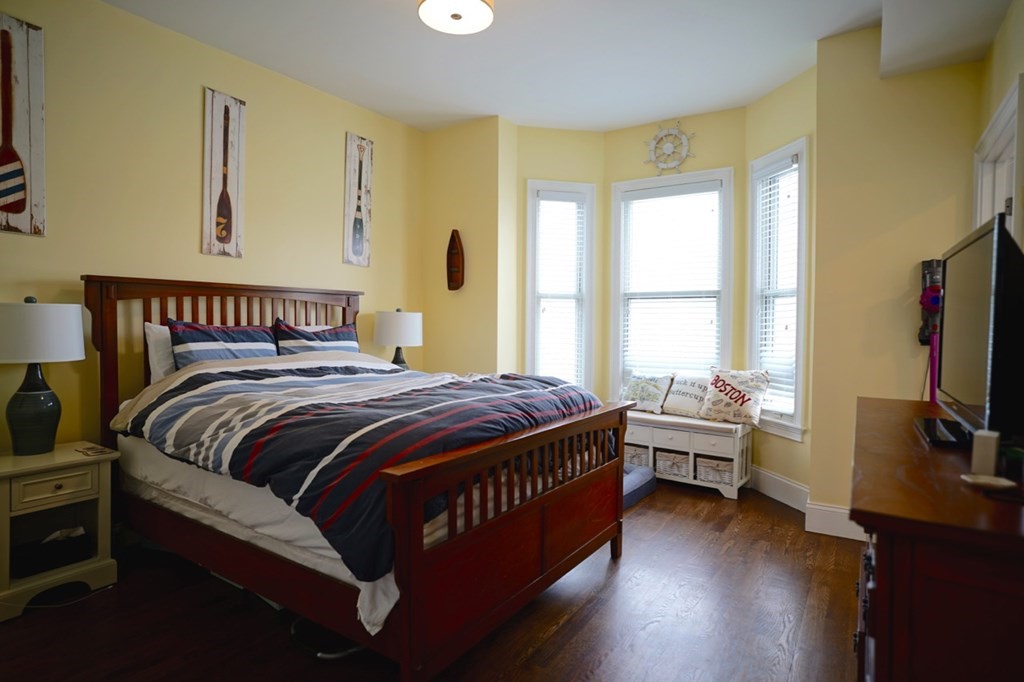 249 Lexington Street, Unit 2 Boston, MA 02128 - Photo 8 of 28 a bedroom with a bed and a flat screen tv