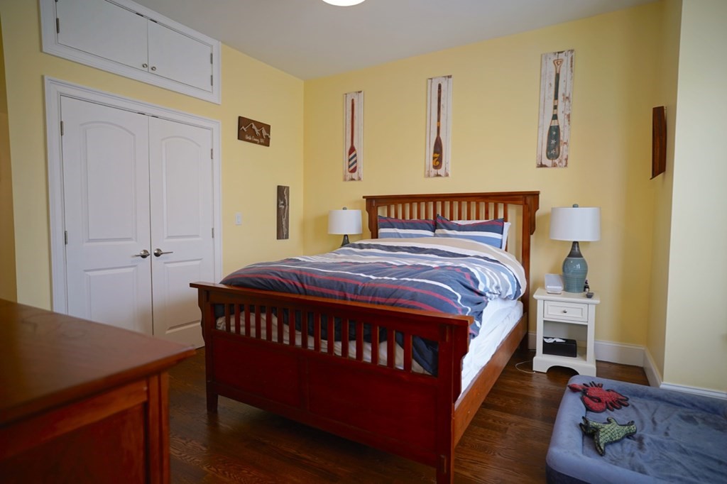 249 Lexington Street, Unit 2 Boston, MA 02128 - Photo 9 of 28 a bedroom with a bed and wooden floor