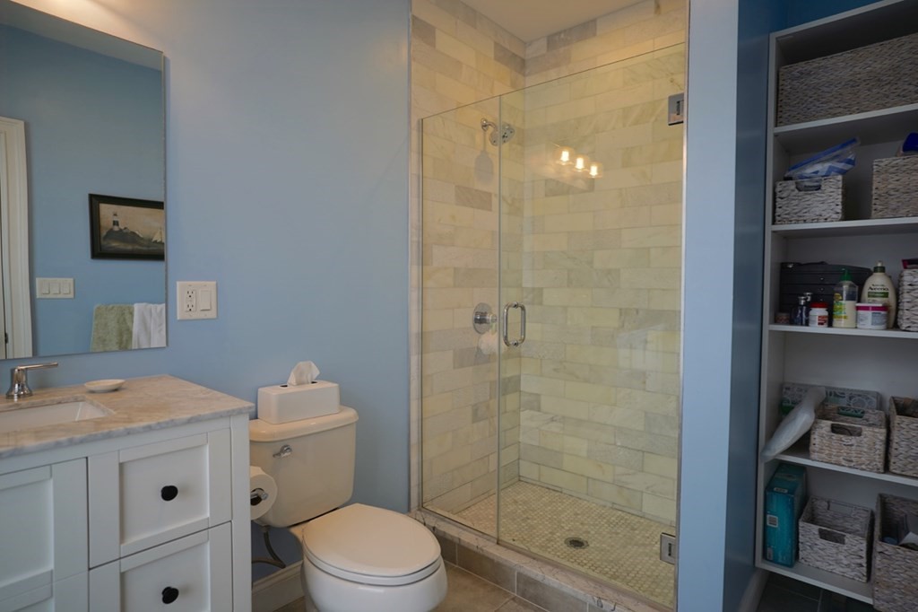 249 Lexington Street, Unit 2 Boston, MA 02128 - Photo 10 of 28 a bathroom with a granite countertop sink a toilet and shower