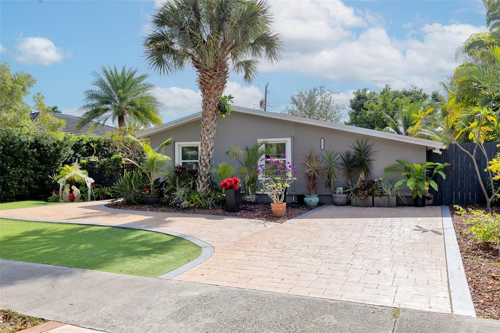 3194 Taft Street Hollywood, FL 33021 - Photo 1 of 48 a view of a house with a small yard and a palm tree