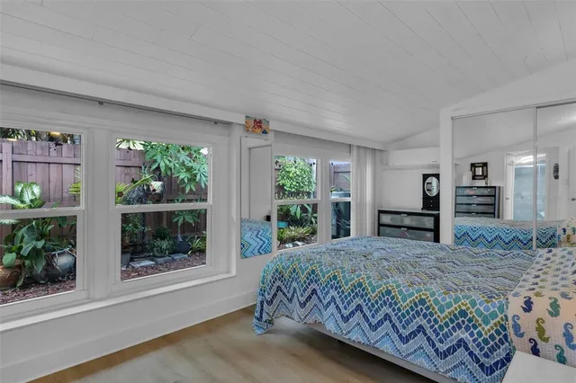 a bedroom with a large bed and a window