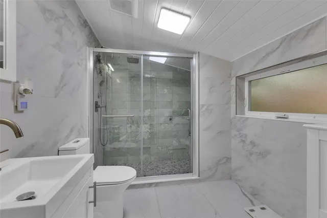 a bathroom with a shower and a sink