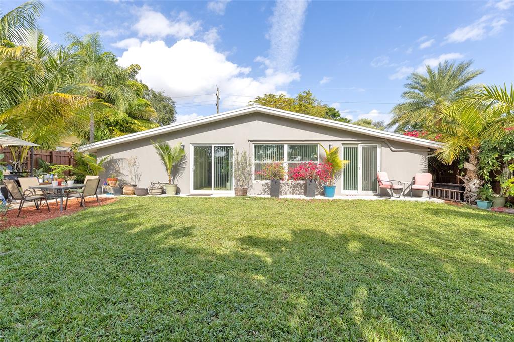 3194 Taft Street Hollywood, FL 33021 - Photo 39 of 48 a view of a house with a big yard and potted plants