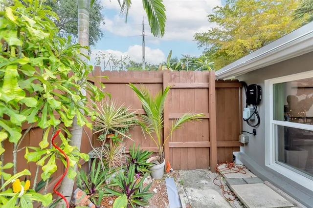 a view of a chair and table in backyard of the house