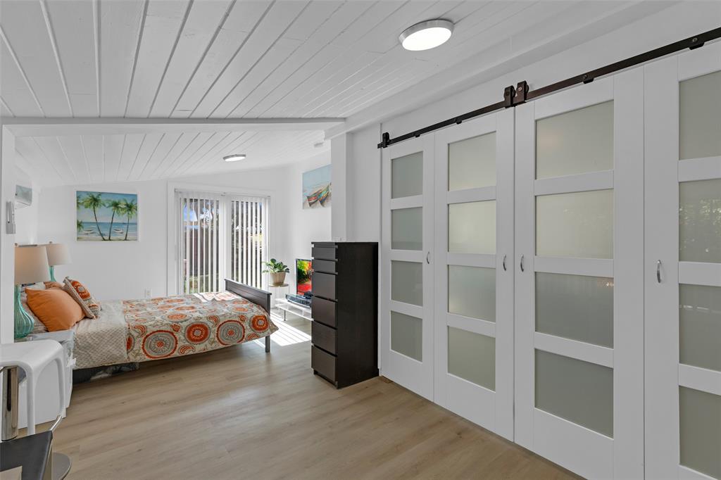 3194 Taft Street Hollywood, FL 33021 - Photo 8 of 48 a bedroom with bed and window