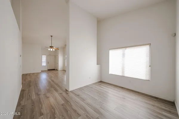 a view of empty room with wooden floor