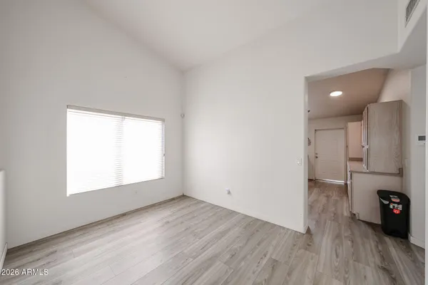 an empty room with wooden floor and a window