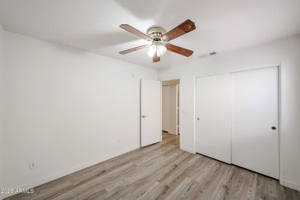 a view of an empty room with wooden floor