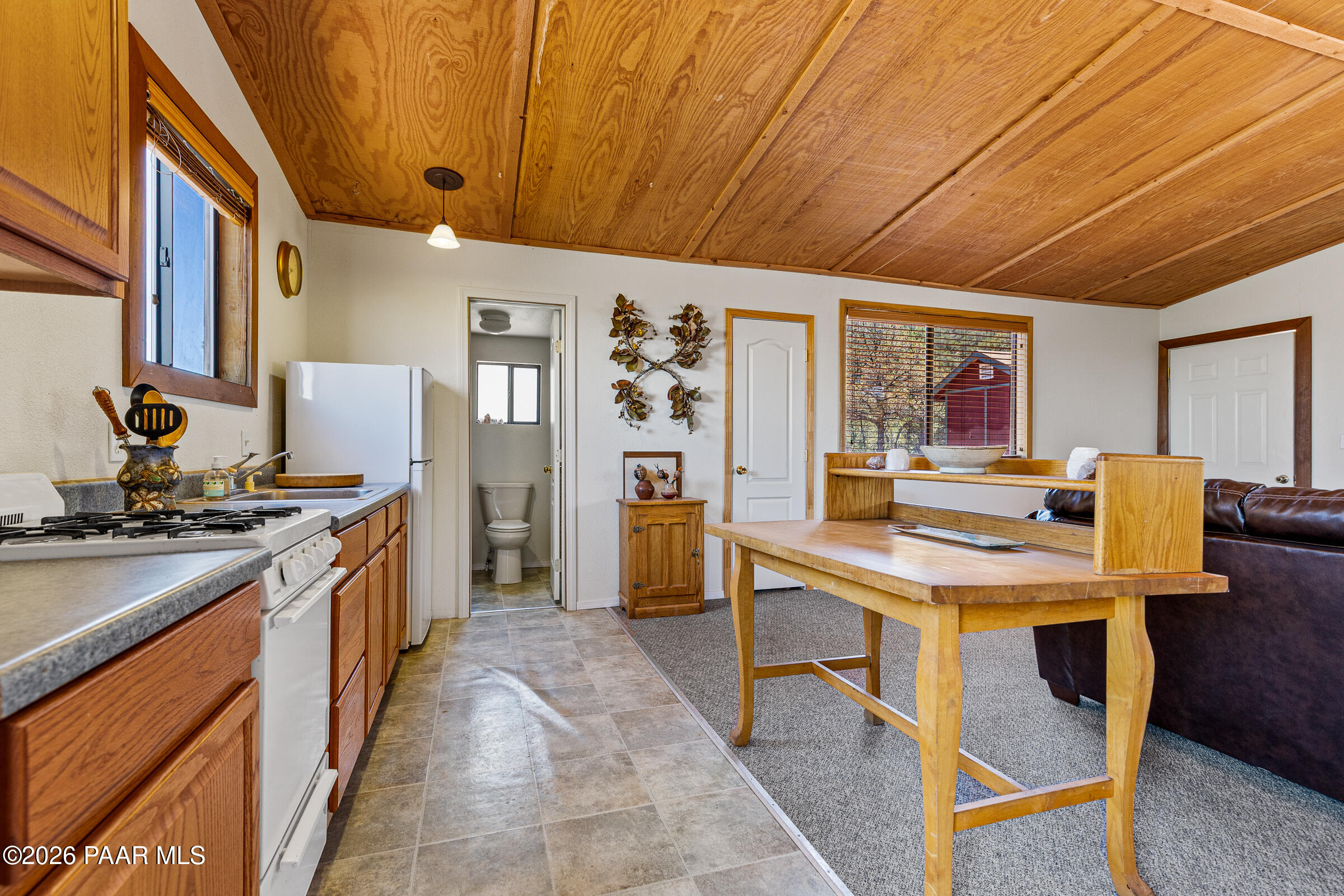 33749 West Whiskey River Road, Unit 21 Seligman, AZ 86337 - Photo 14 of 41 a kitchen with stainless steel appliances granite countertop a stove kitchen island a table and chairs