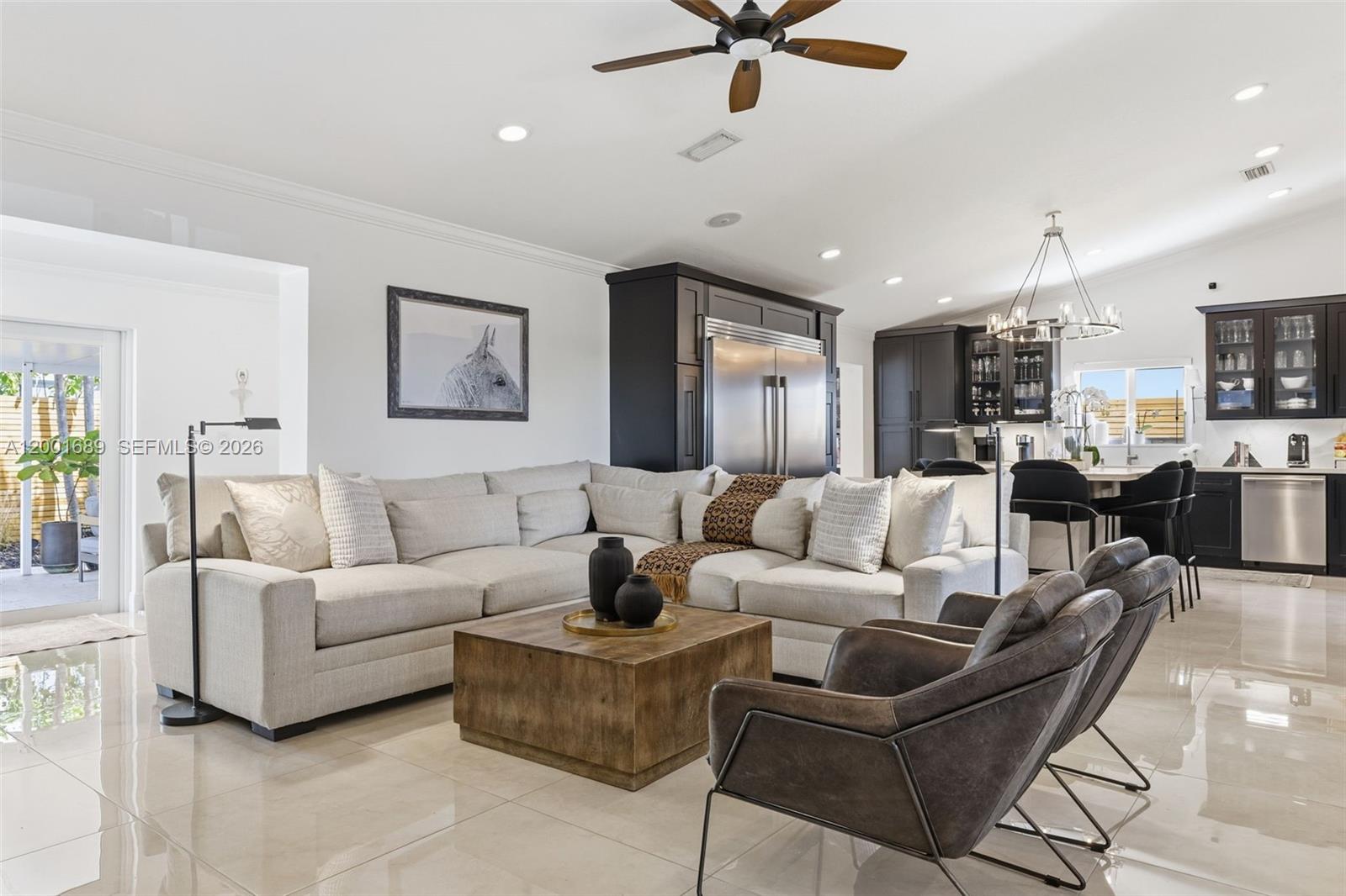 14491 Southwest 161 Street Miami, FL 33177 - Photo 11 of 55 a living room with furniture kitchen view and a flat screen tv