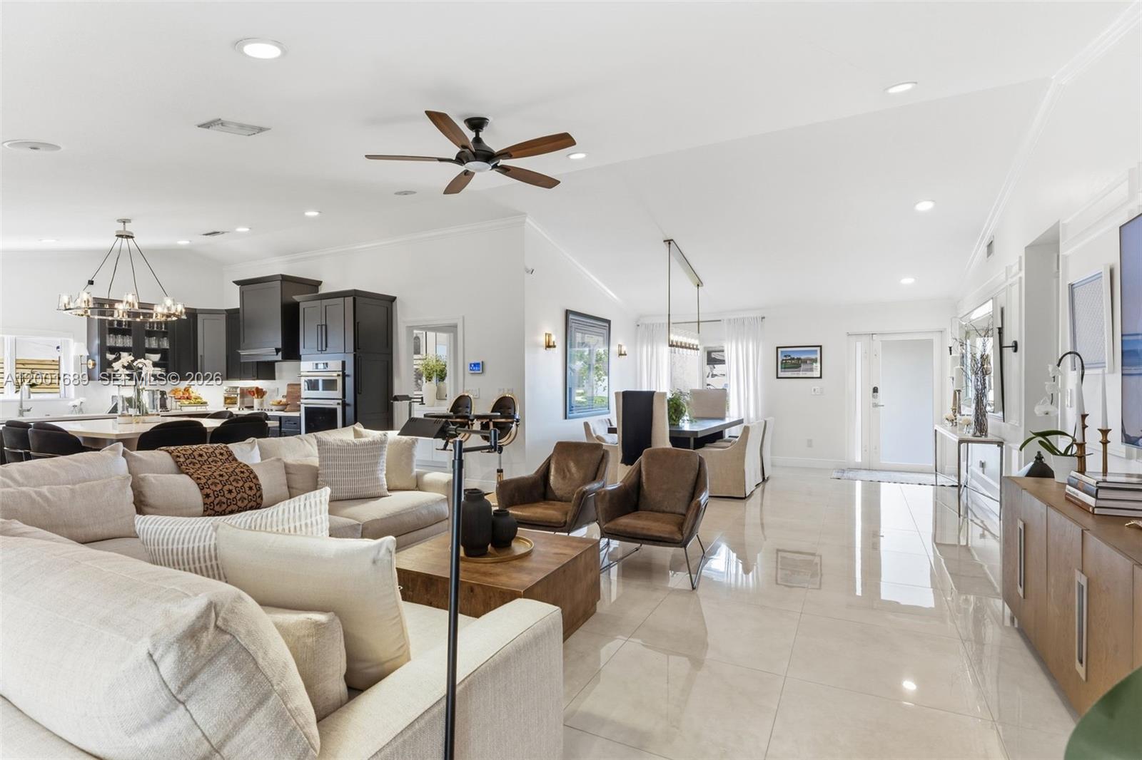 14491 Southwest 161 Street Miami, FL 33177 - Photo 12 of 55 a living room with furniture kitchen view and a chandelier