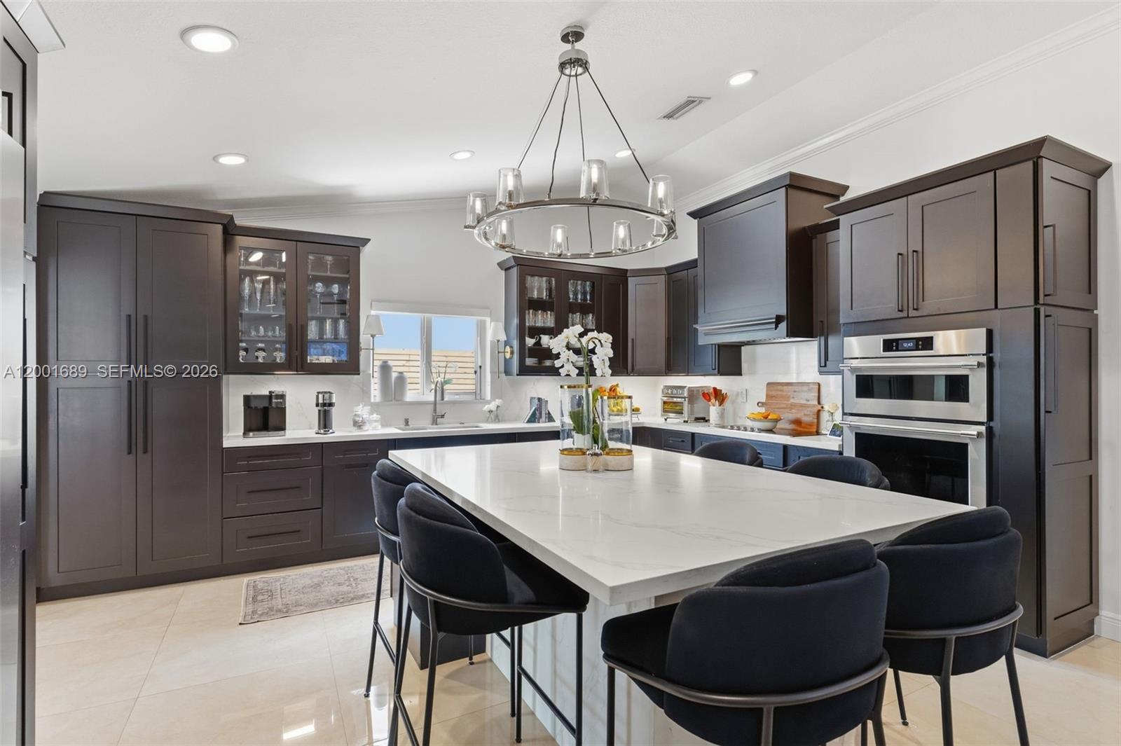 14491 Southwest 161 Street Miami, FL 33177 - Photo 17 of 55 a kitchen with stainless steel appliances a dining table chairs stove refrigerator and microwave