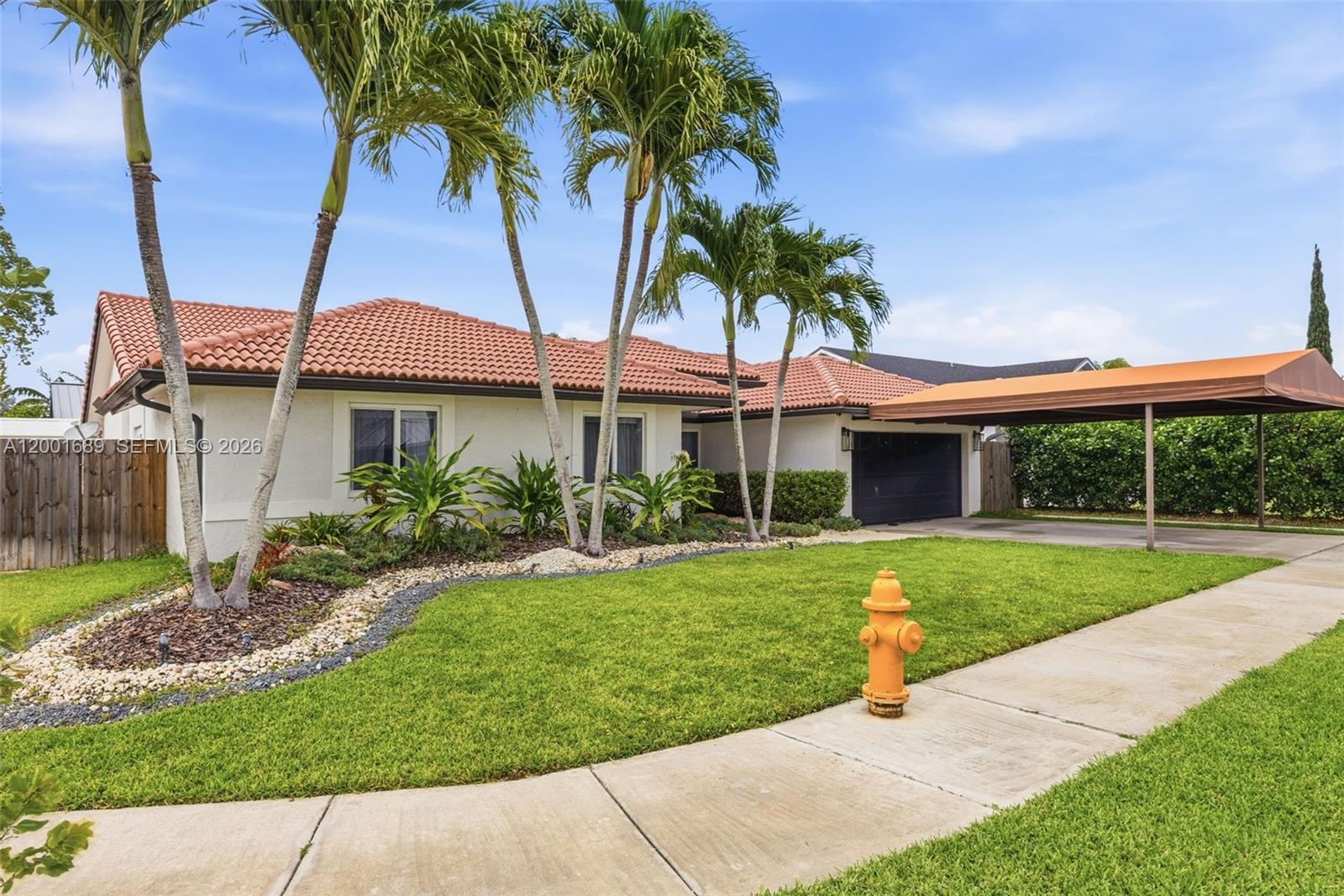 14491 Southwest 161 Street Miami, FL 33177 - Photo 2 of 55 a view of a backyard with a garden and palm trees