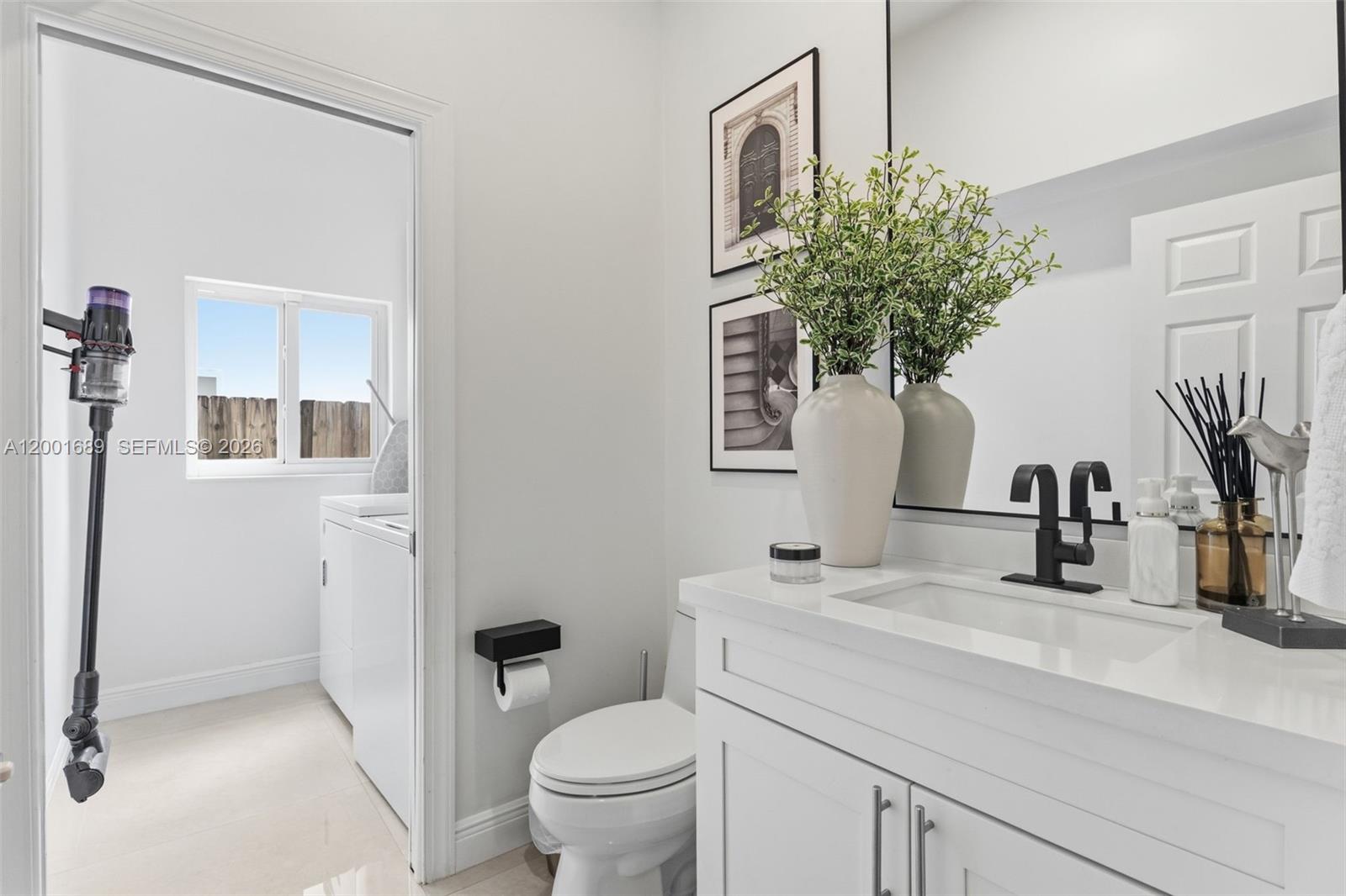 14491 Southwest 161 Street Miami, FL 33177 - Photo 25 of 55 a bathroom with a toilet sink and mirror