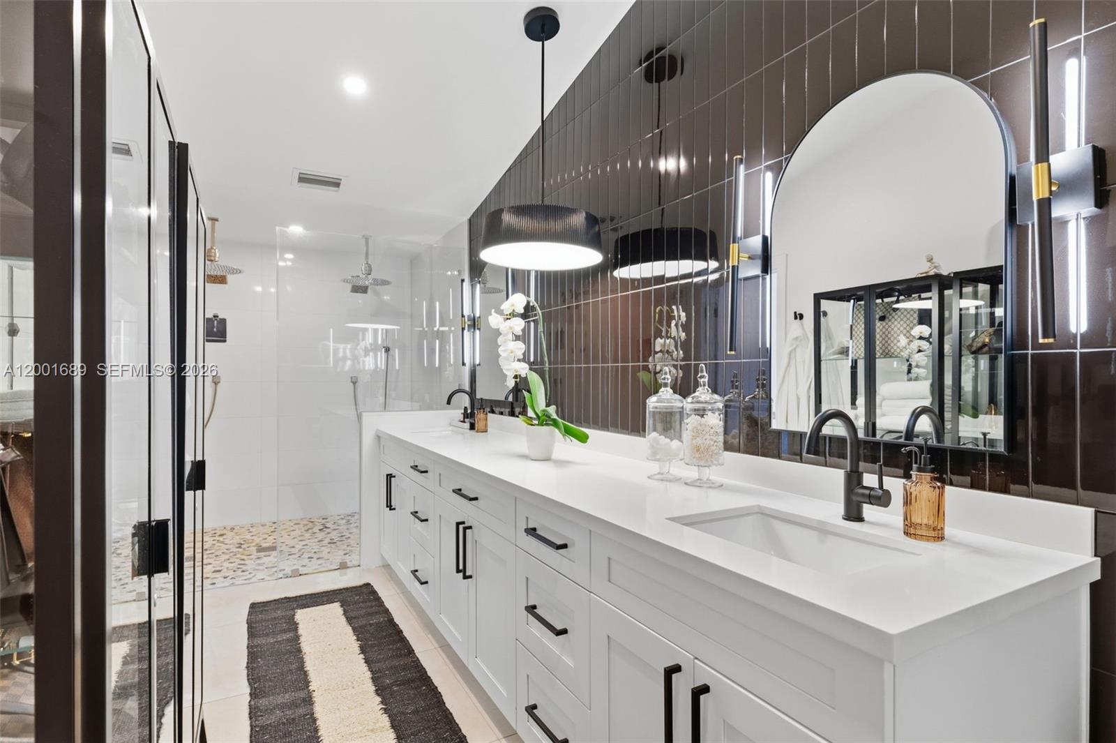 14491 Southwest 161 Street Miami, FL 33177 - Photo 34 of 55 a bathroom with a double vanity sink mirror and shower