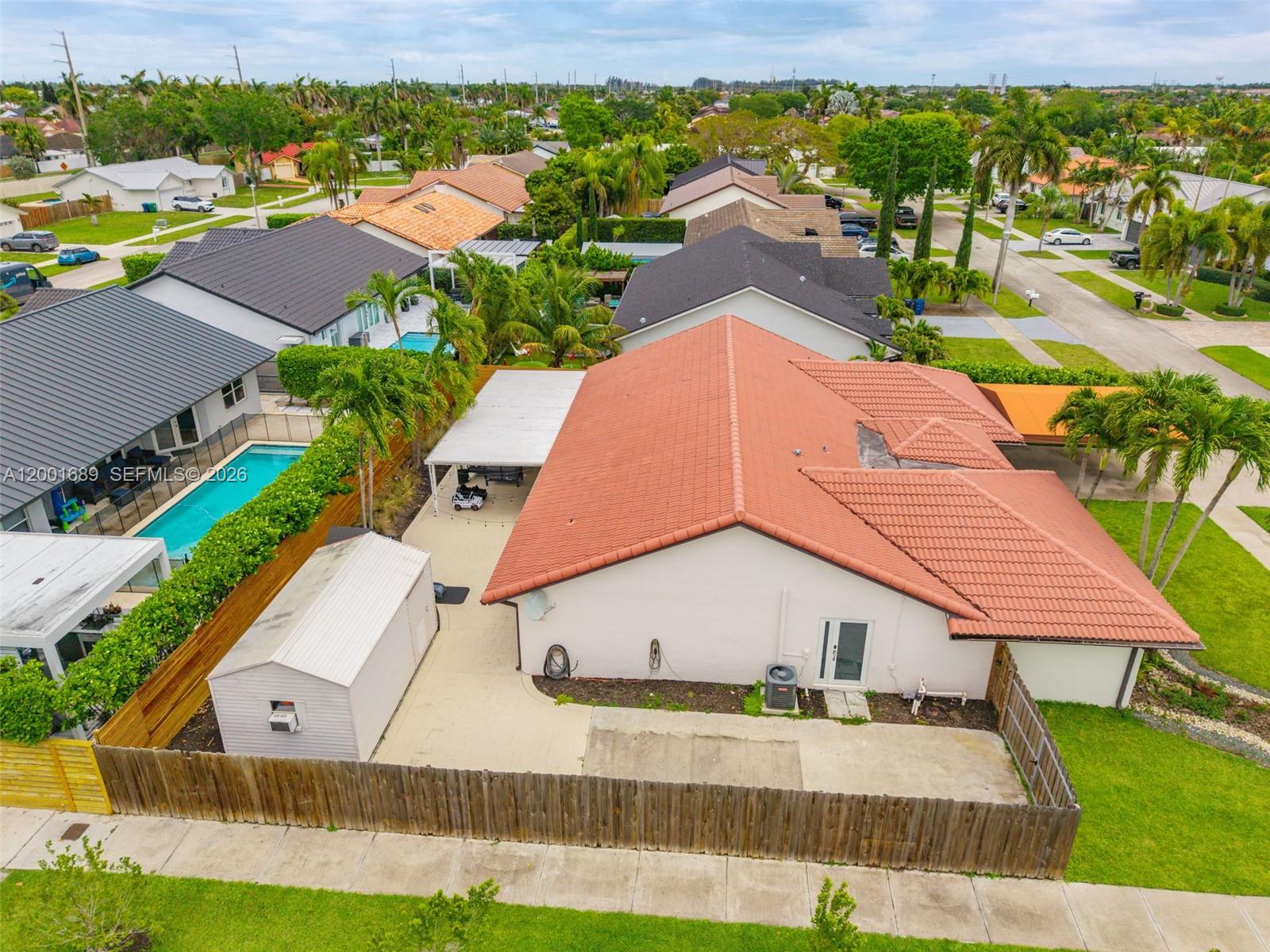 14491 Southwest 161 Street Miami, FL 33177 - Photo 54 of 55 an aerial view of residential houses with yard and swimming pool