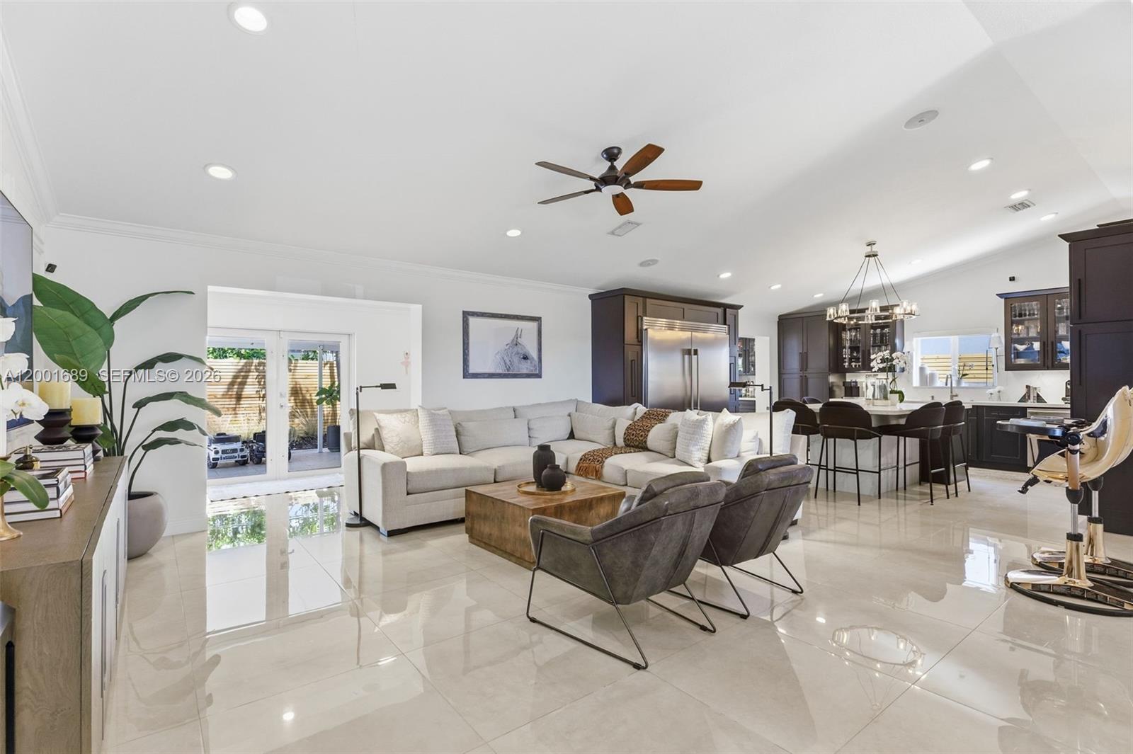 14491 Southwest 161 Street Miami, FL 33177 - Photo 10 of 55 a living room with furniture kitchen view and a chandelier